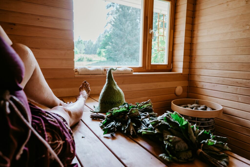 Woman in sauna with herbs