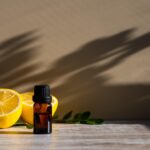 Essential Oil bottle and lemons on a wellness background