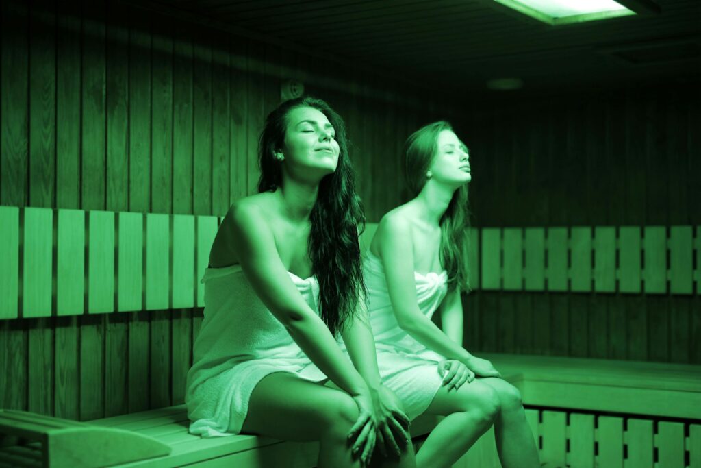 two girls inside infrared sauna 