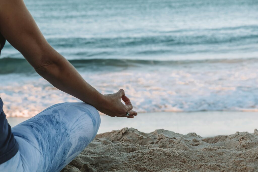 Woman meditating on the beach