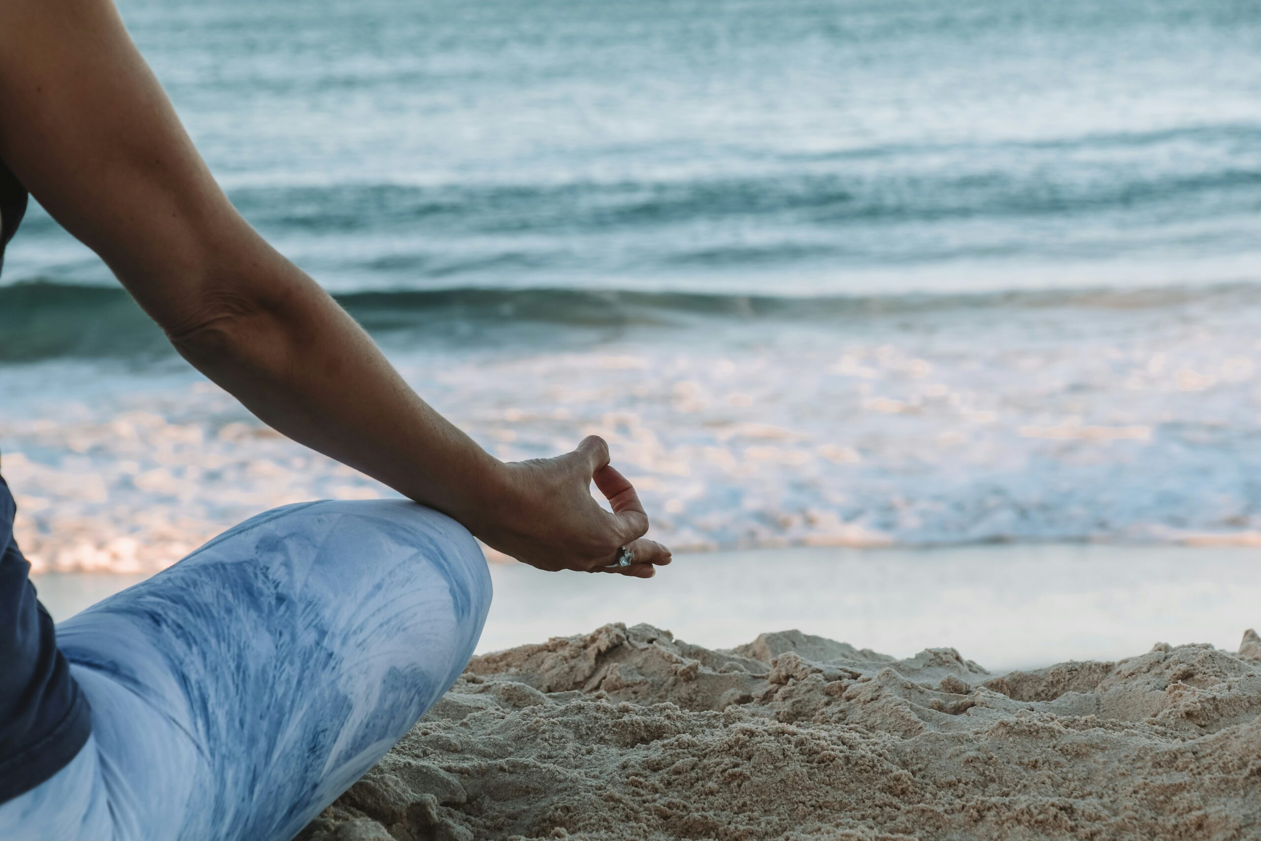 Woman meditating on the beach