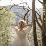 Woman in white dress practicing forest bathing