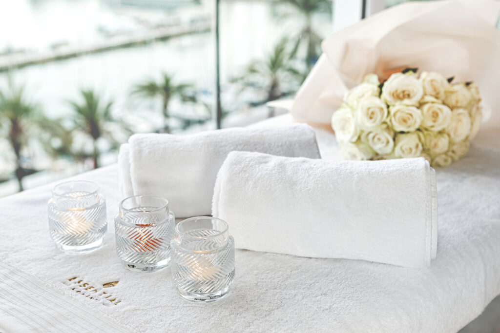 Professional Massage Bed Setup, White Roses, Candles, White Towels with Brand Logo Essential-Moments
