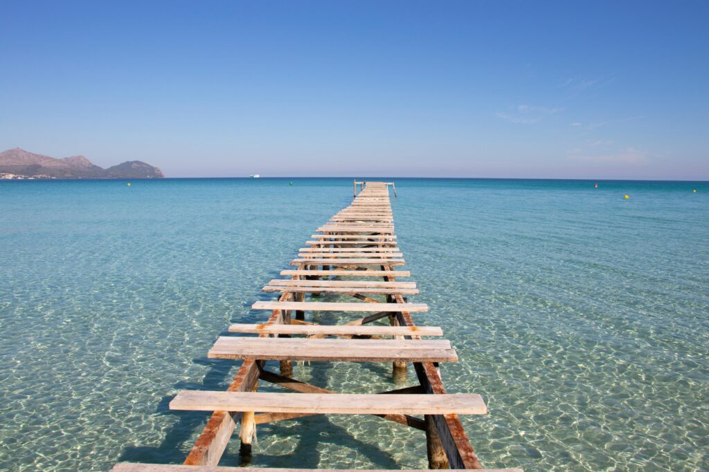 Walking bridge on top of clear sea water