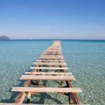 Walking bridge on top of clear sea water