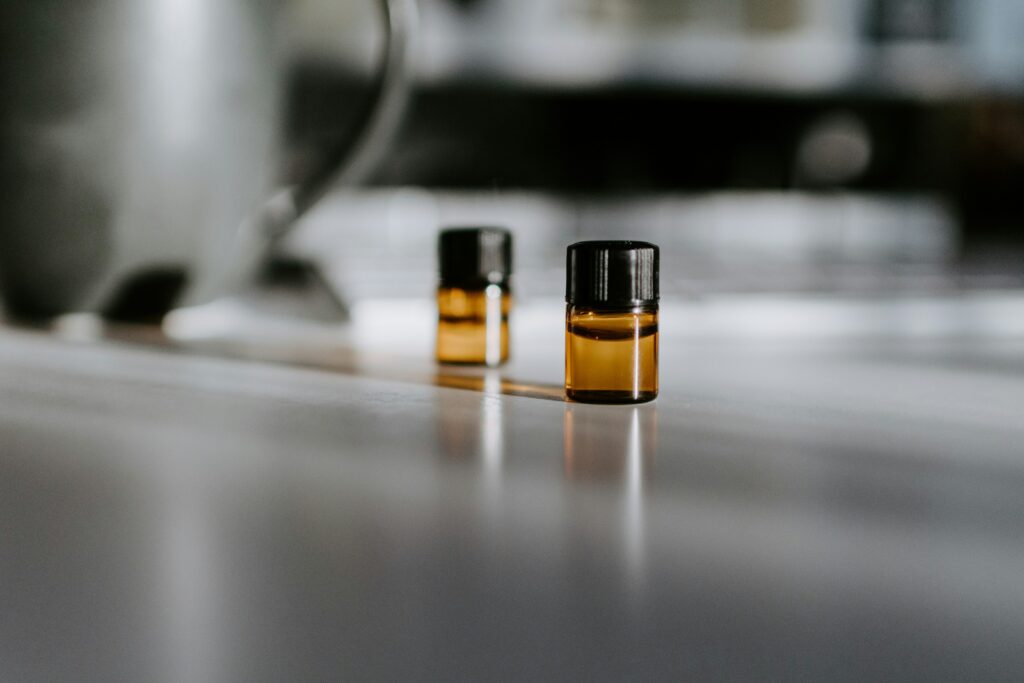 Two bottles of skin care oil on a table and grey background