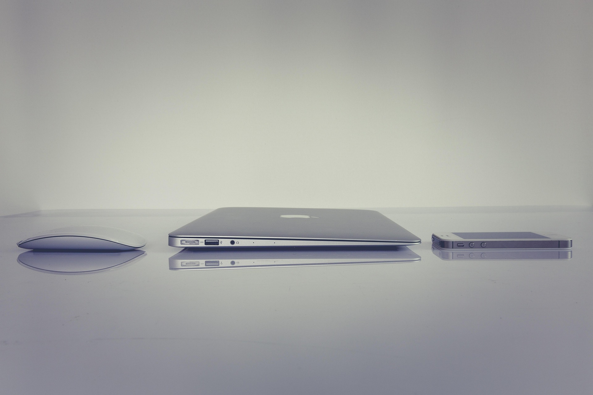 Apple computer, mouse and iphone on a table