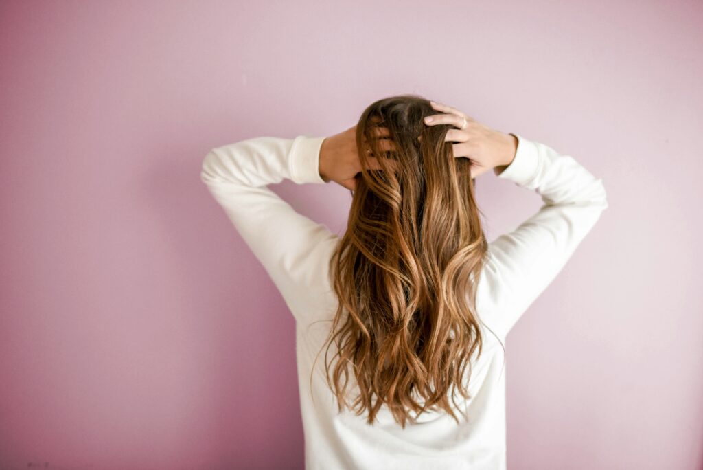 Head massage, woman with long brown hair touching her had 