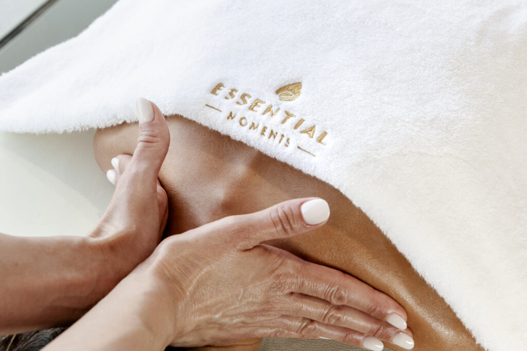 Neck and shoulder massage on client with Essential Moments white towel