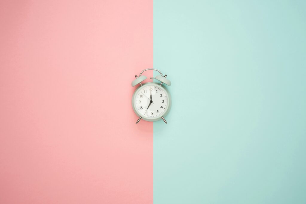 Watch in the middle of a pink and green background