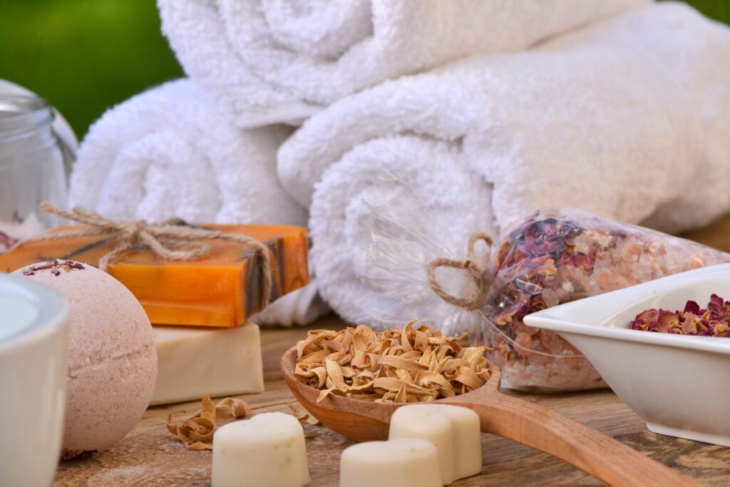 White spa towels, colored spa soaps and dry flowers for scent