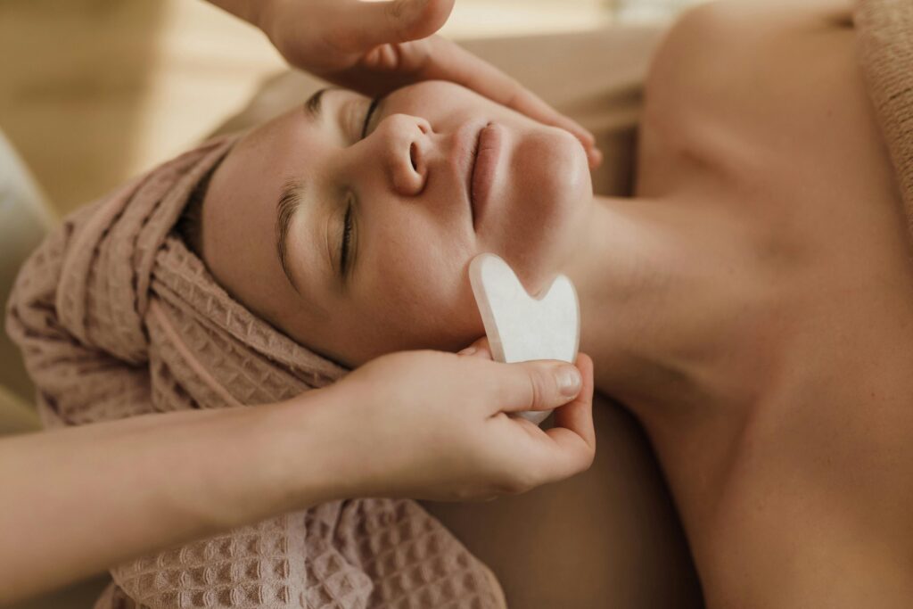 Guasha face massage on client