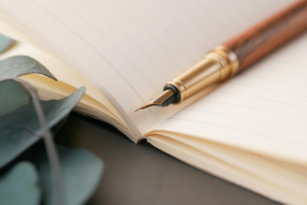 Notebook and ancient pen on top