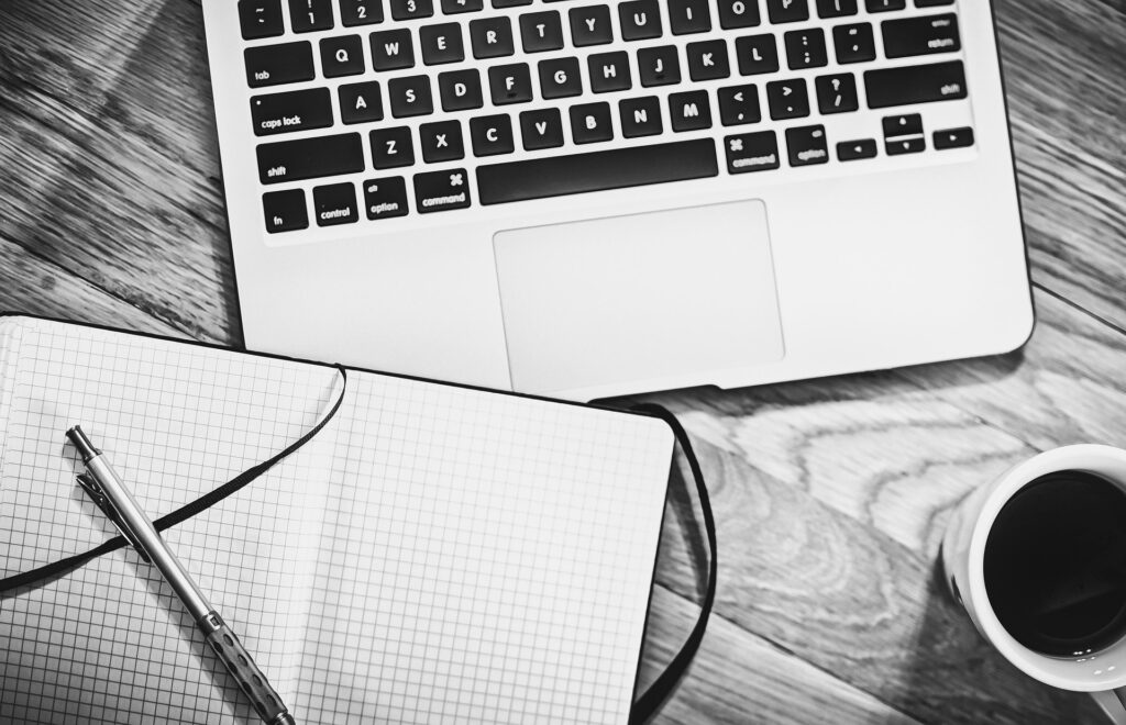 Boocking App for massage bsuuiness, computer , notebook with a pen and coffee 