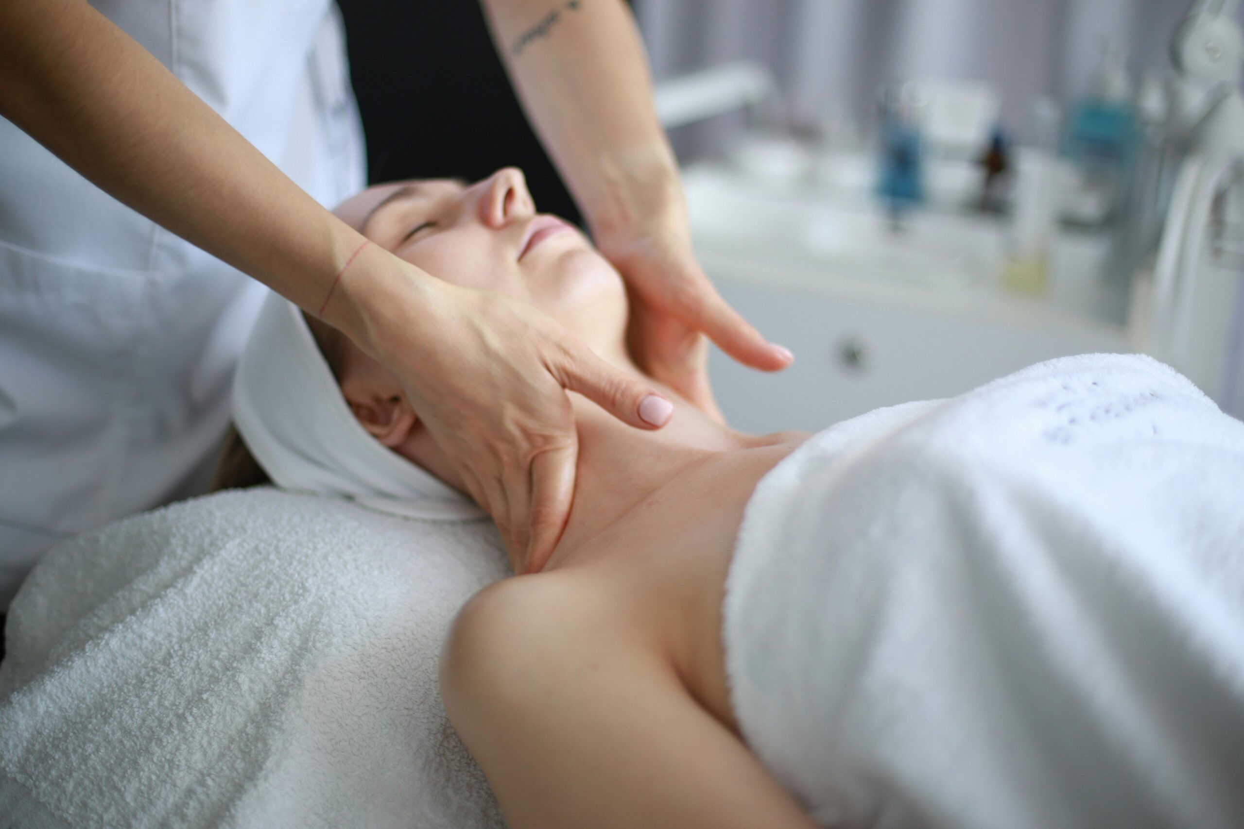 Premium massage experience, client receiving a neck massage from therapist